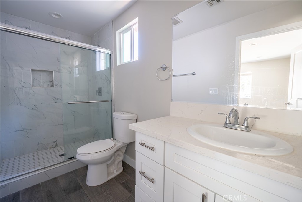 7022 Crebs Avenue Reseda, CA 91335 - Photo 17 of 20 a bathroom with a sink toilet and shower