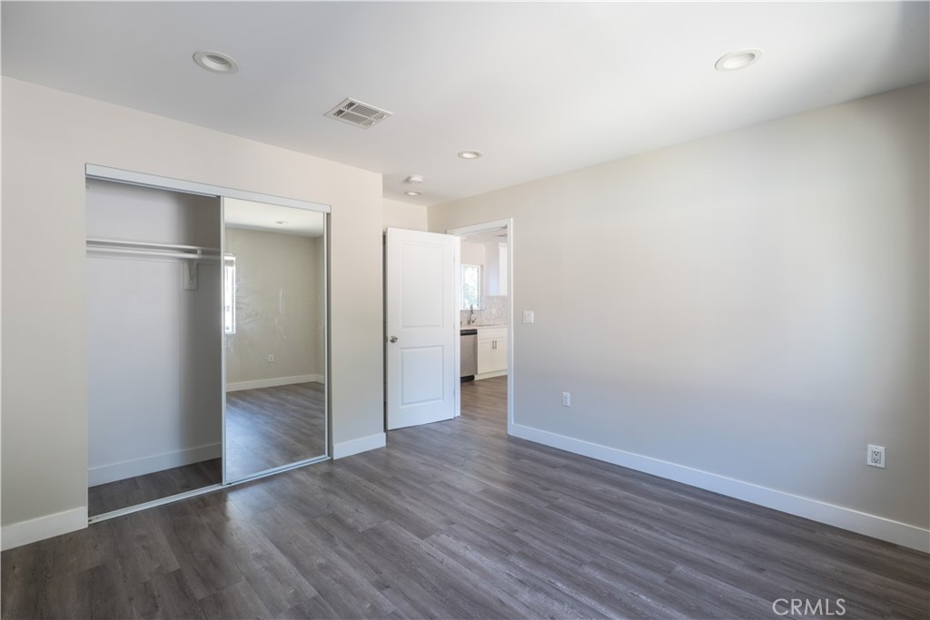 7022 Crebs Avenue Reseda, CA 91335 - Photo 18 of 20 a view of an empty room with wooden floor and a bathroom
