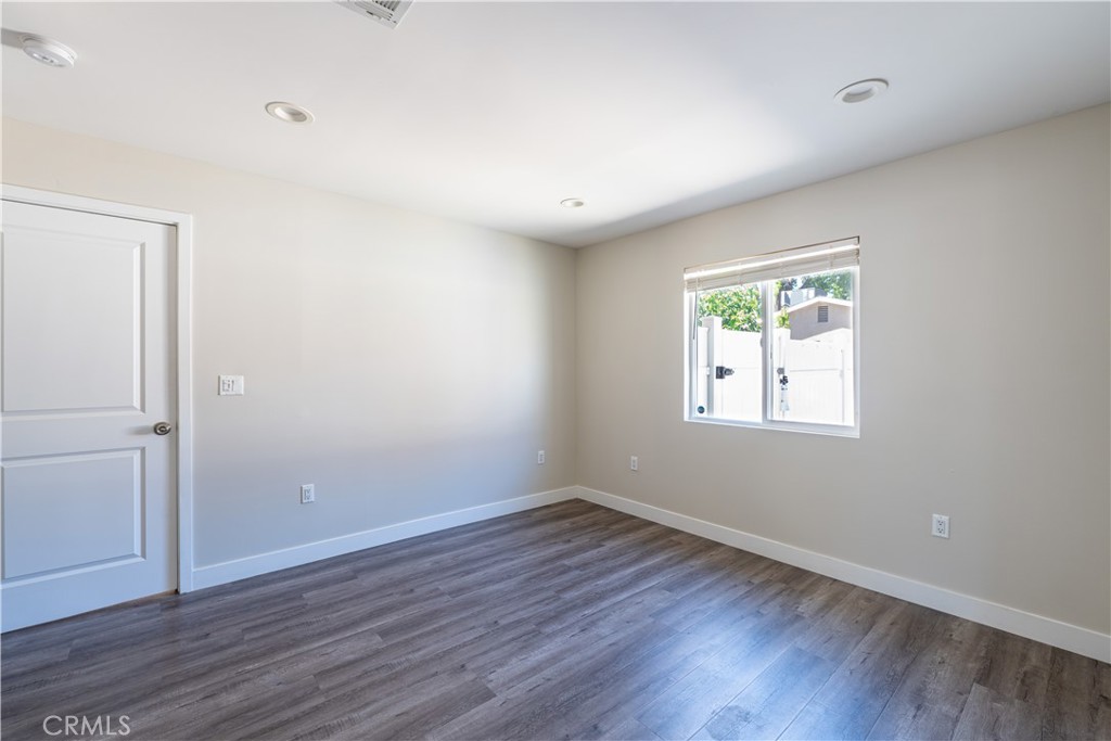 7022 Crebs Avenue Reseda, CA 91335 - Photo 20 of 20 an empty room with wooden floor and windows