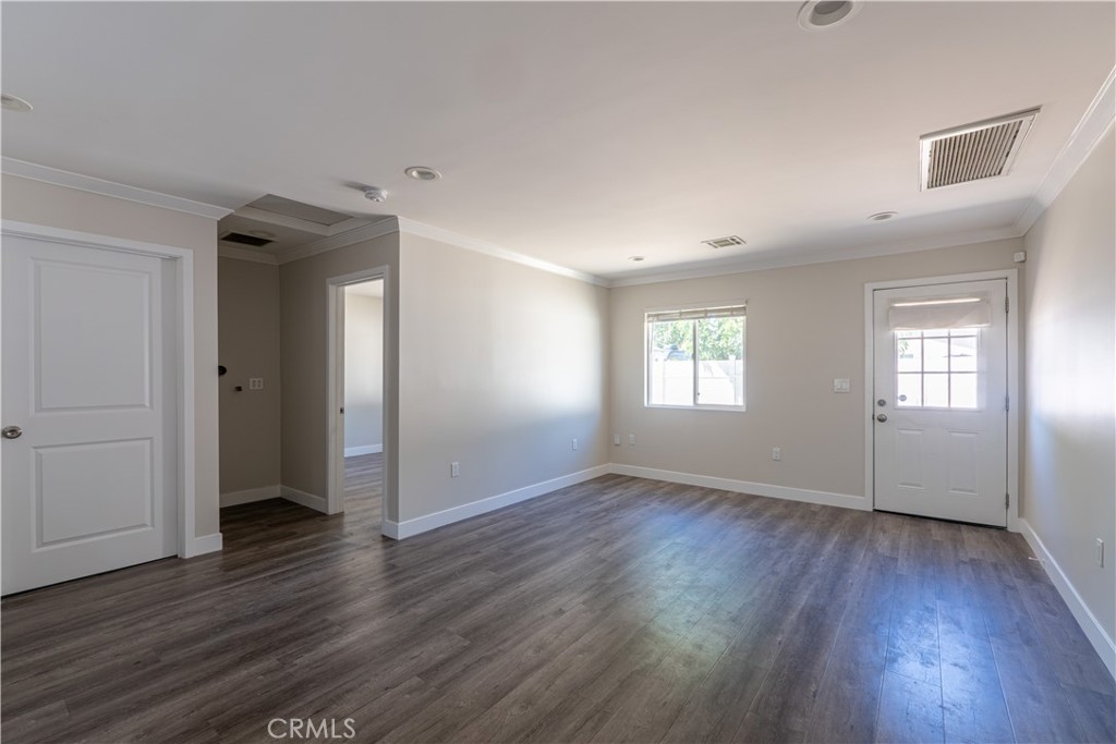 7022 Crebs Avenue Reseda, CA 91335 - Photo 5 of 20 an empty room with wooden floor and windows