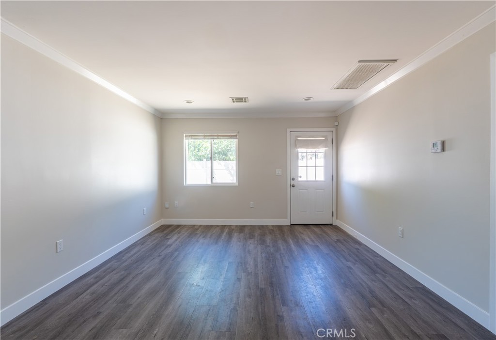 7022 Crebs Avenue Reseda, CA 91335 - Photo 6 of 20 an empty room with wooden floor and windows