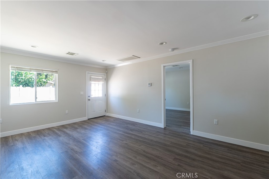 7022 Crebs Avenue Reseda, CA 91335 - Photo 7 of 20 an empty room with wooden floor and windows