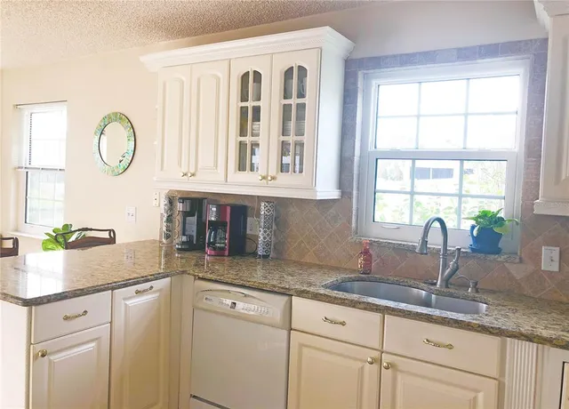 a kitchen with sink and window