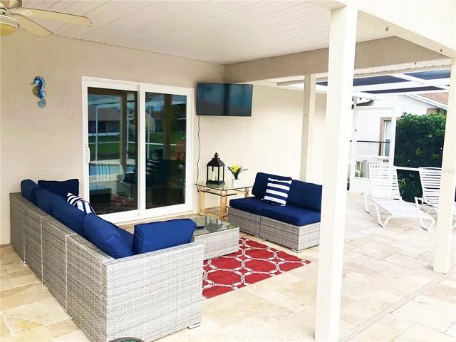 a living room with furniture and large windows