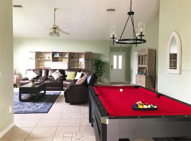 a living room with furniture and chandelier