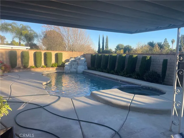 a view of living room with furniture and a floor to ceiling window