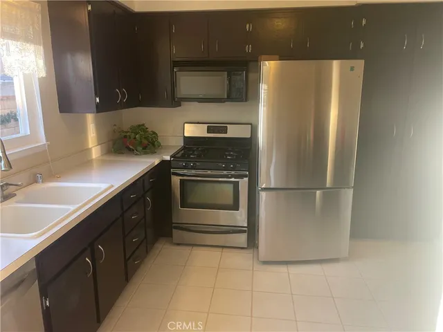 a kitchen with a sink and a refrigerator