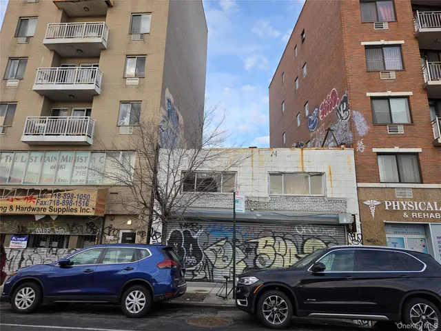 a front view of a building with parking space
