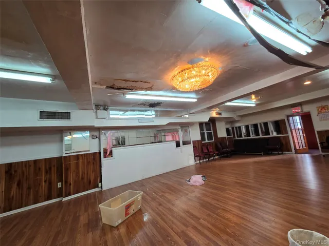a view of a room with wooden floors and a window