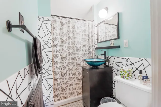 a white toilet sitting next to a bathroom sink