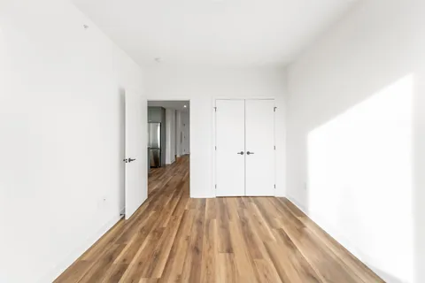 a view of a room with wooden floor