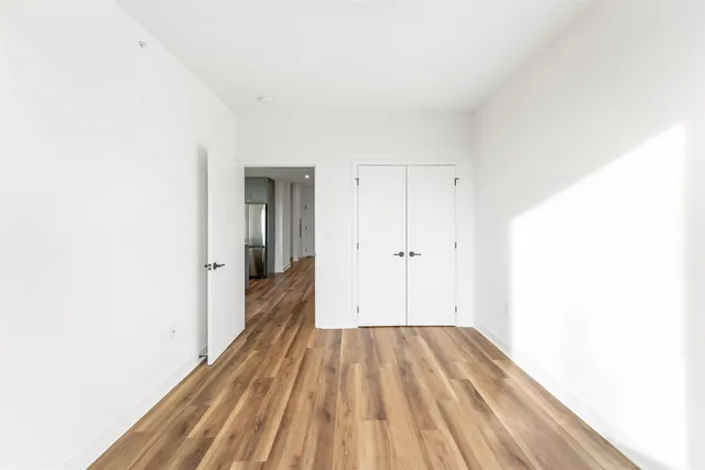 a view of a room with wooden floor