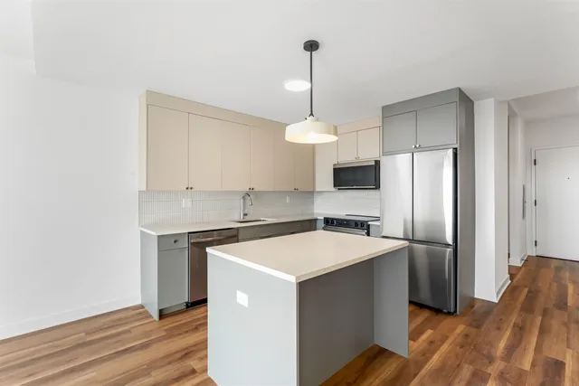 a kitchen that has a stainless steel appliances a counter space and a refrigerator