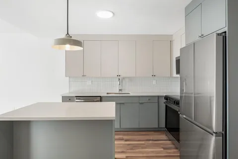 a kitchen with stainless steel appliances a sink stove and refrigerator