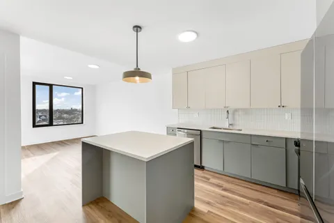 a kitchen with a sink cabinets and window
