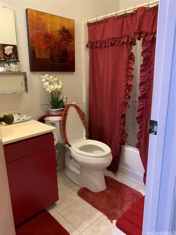 a bathroom with a toilet a sink and curtain