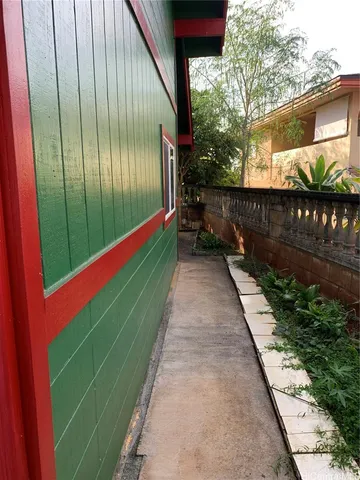a backyard with potted plants and a wooden bench