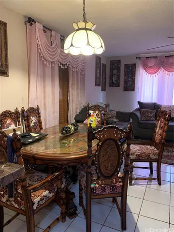 a view of a dining room with furniture and chandelier