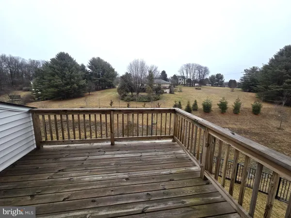 a balcony with wooden floor and lake view