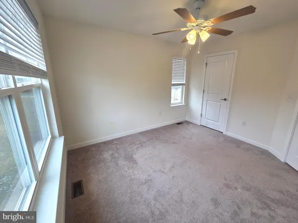 a bathroom with a double vanity sink toilet and a mirror