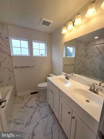 a bathroom with a bathtub and a sink