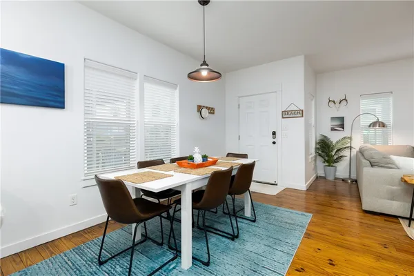 a view of a dining room with furniture window and wooden floor