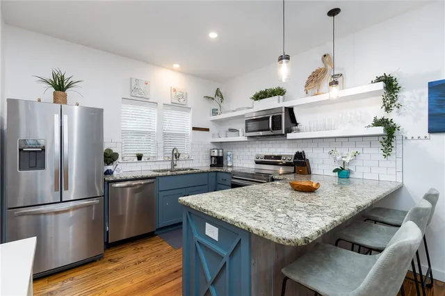 a kitchen with sink cabinets and stainless steel appliances
