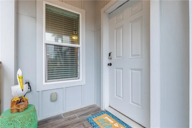 a view of an entryway with wooden floor
