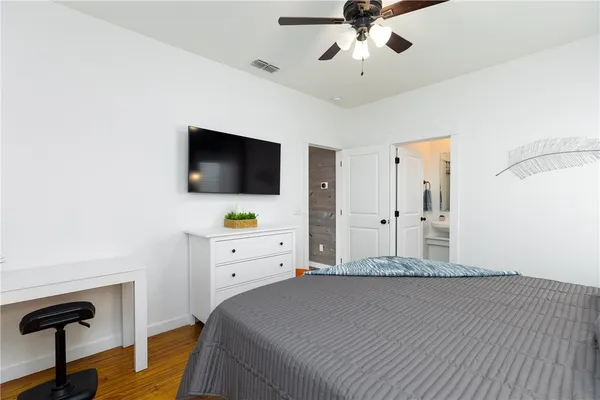 a bedroom with a bed and a flat screen tv