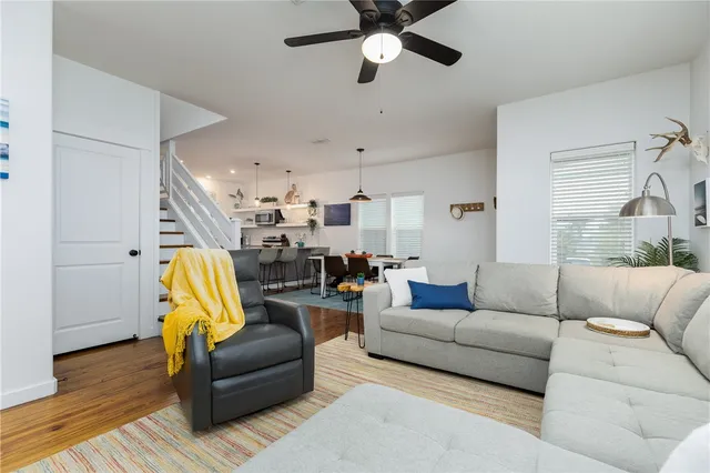 a living room with furniture and a wooden floor