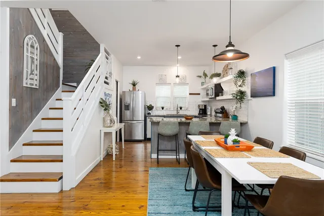 a dining room with furniture and wooden floor