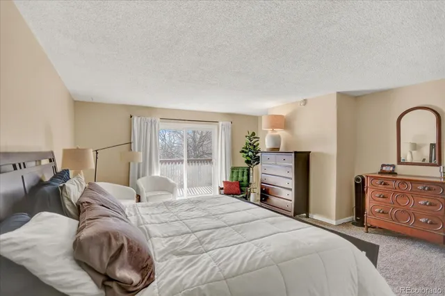 a bedroom with a bed and a dresser with mirror