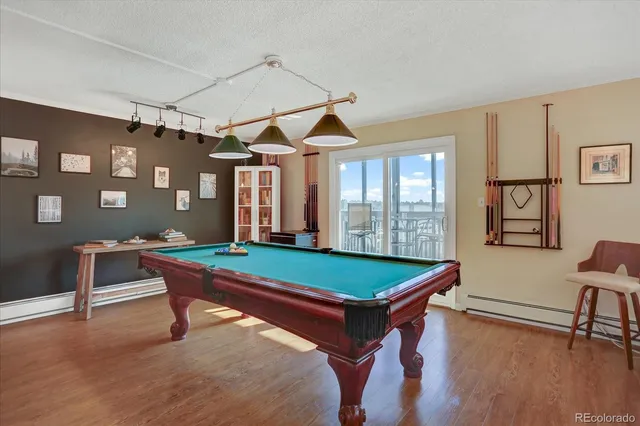 a room with pool table and windows