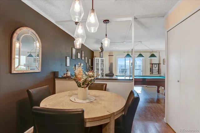 a view of a dining room with furniture and a chandelier