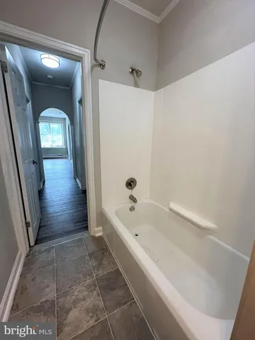 a bathroom with bathtub and a shower