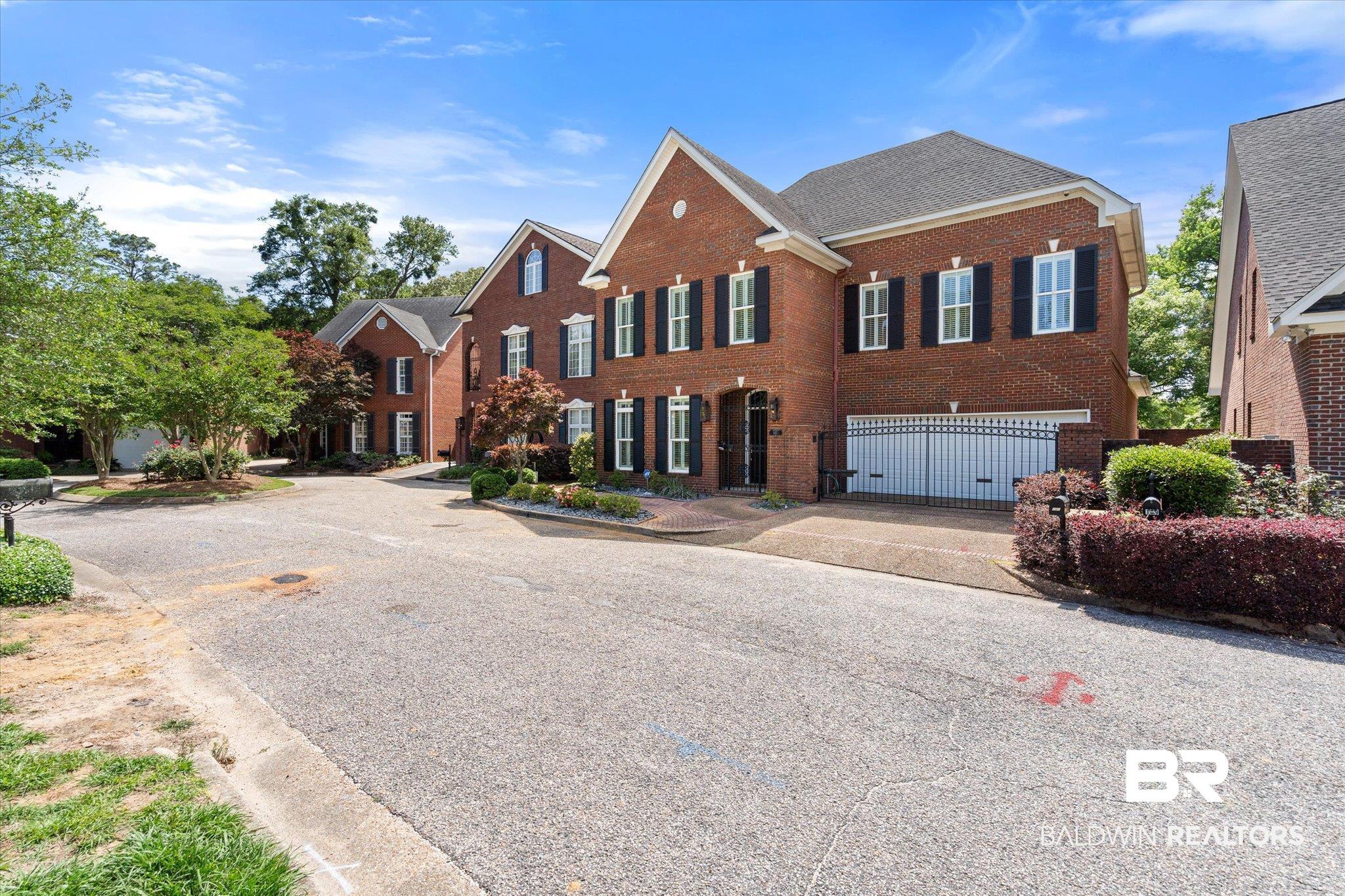 107 Fielding Place Mobile, AL 36608 - Photo 22 of 27 View of front of house with a garage, brick siding, and driveway