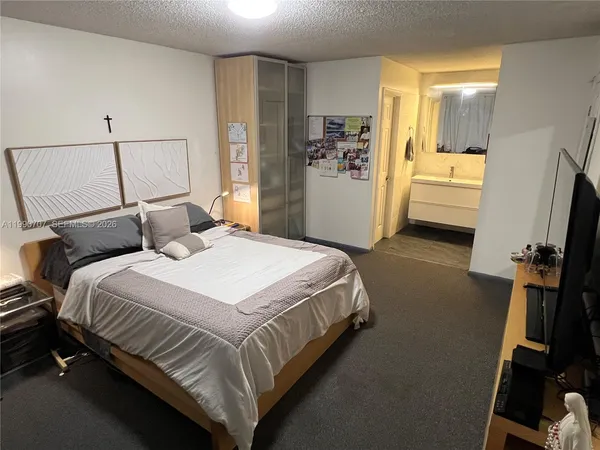 a bedroom with a bed and a walk in closet