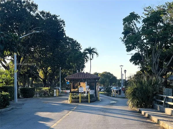 a view of a park with bench and trees