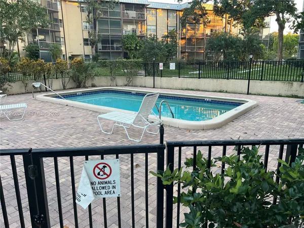 a view of a backyard with a tub and seating space