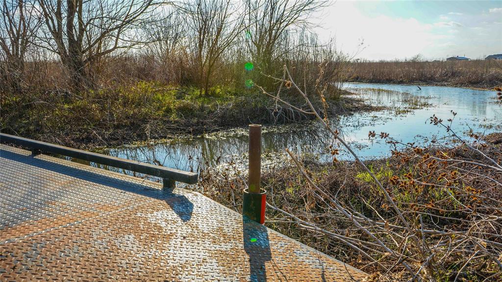 Tbd Camp Creek Road Temple, TX 76501 - Photo 30 of 40 a view of a lake with a bench and trees
