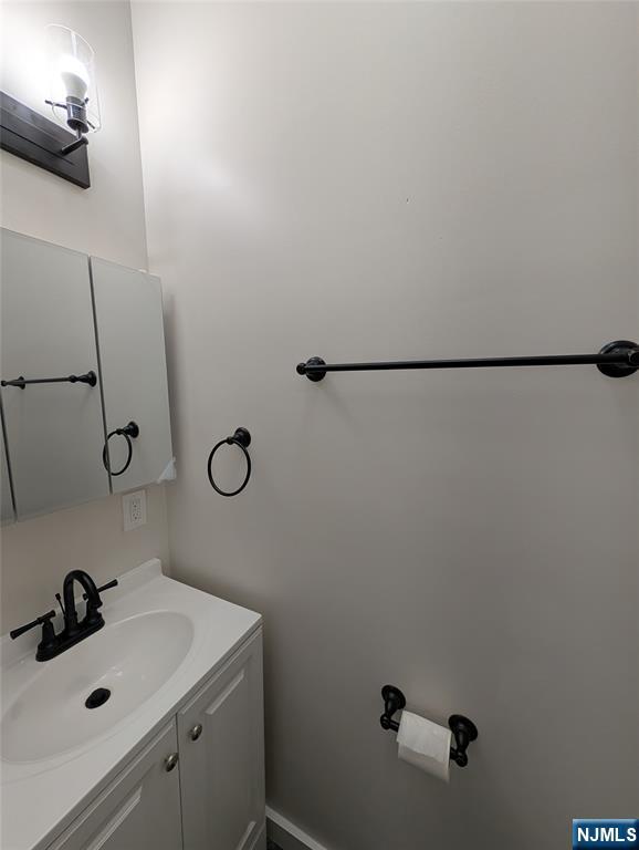 69 Howe Avenue, Unit 9 Passaic, NJ 07055 - Photo 11 of 20 a bathroom with a sink and mirror