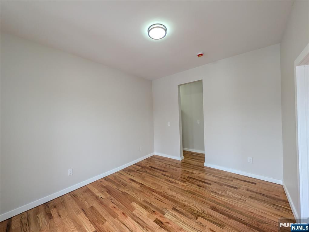 69 Howe Avenue, Unit 9 Passaic, NJ 07055 - Photo 15 of 20 a view of empty room with wooden floor