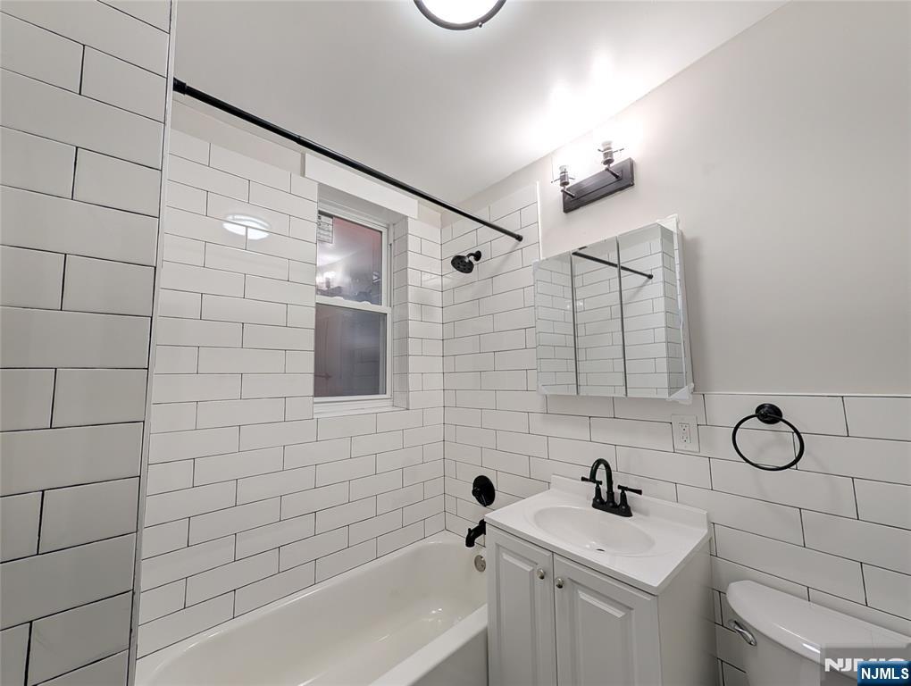 69 Howe Avenue, Unit 9 Passaic, NJ 07055 - Photo 19 of 20 a bathroom with a sink toilet and shower