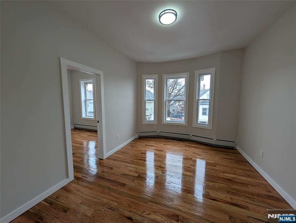 69 Howe Avenue, Unit 9 Passaic, NJ 07055 - Photo 4 of 20 wooden floor in an empty room with a window