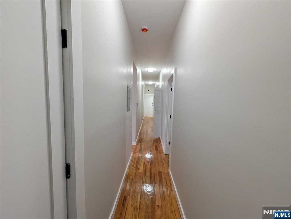 69 Howe Avenue, Unit 9 Passaic, NJ 07055 - Photo 6 of 20 a view of a hallway with wooden floor