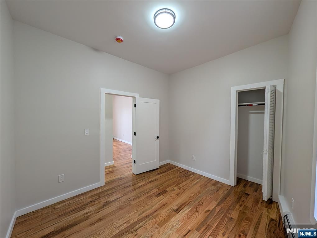 69 Howe Avenue, Unit 9 Passaic, NJ 07055 - Photo 9 of 20 a view of a room with wooden floor and closet