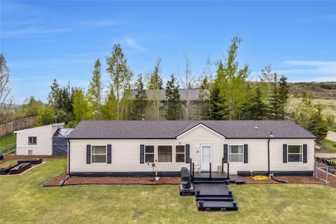 a aerial view of a house with swimming pool and large trees