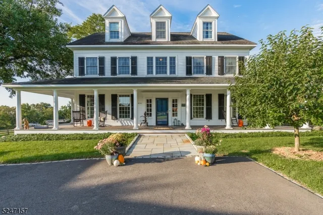 a view of a house with a swimming pool and sitting area
