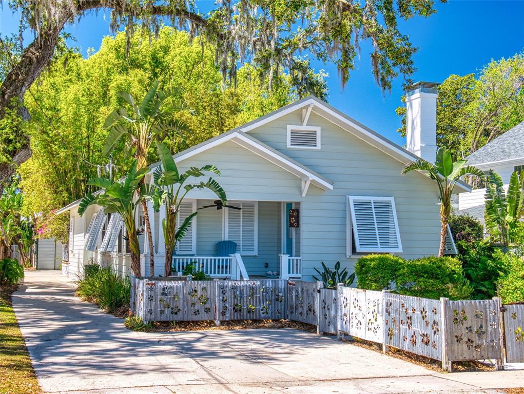 a house that has a tree in front of the house