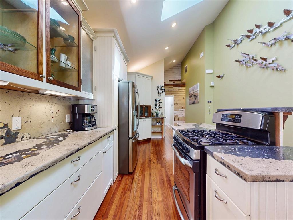 536 Faulkner Street New Smyrna Beach, FL 32168 - Photo 11 of 57 a kitchen with stainless steel appliances granite countertop a stove and a sink